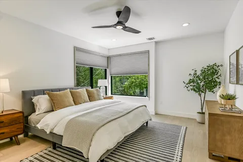 a bedroom with a bed and a potted plant