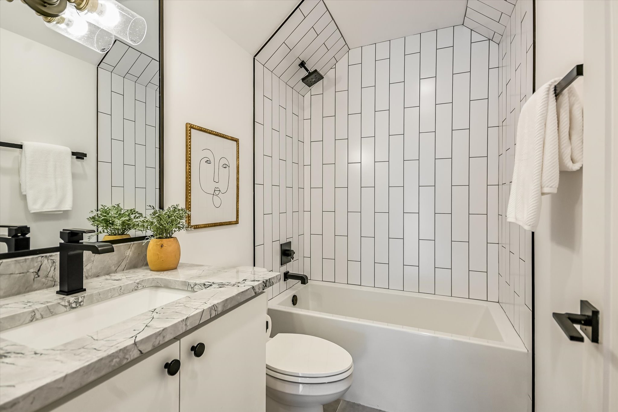 1712 Nash Avenue, Unit A Austin, TX 78704 - Photo 23 of 38 a bathroom with a granite countertop bathtub sink vanity mirror and toilet