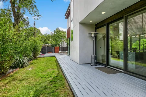 a view of a porch with wooden floor and front door