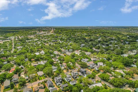 an aerial view of multiple houses with a yard