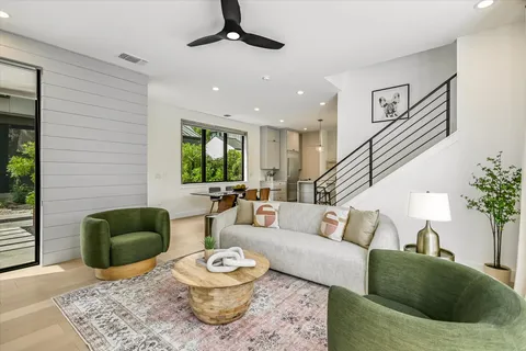 a living room with furniture and wooden floor