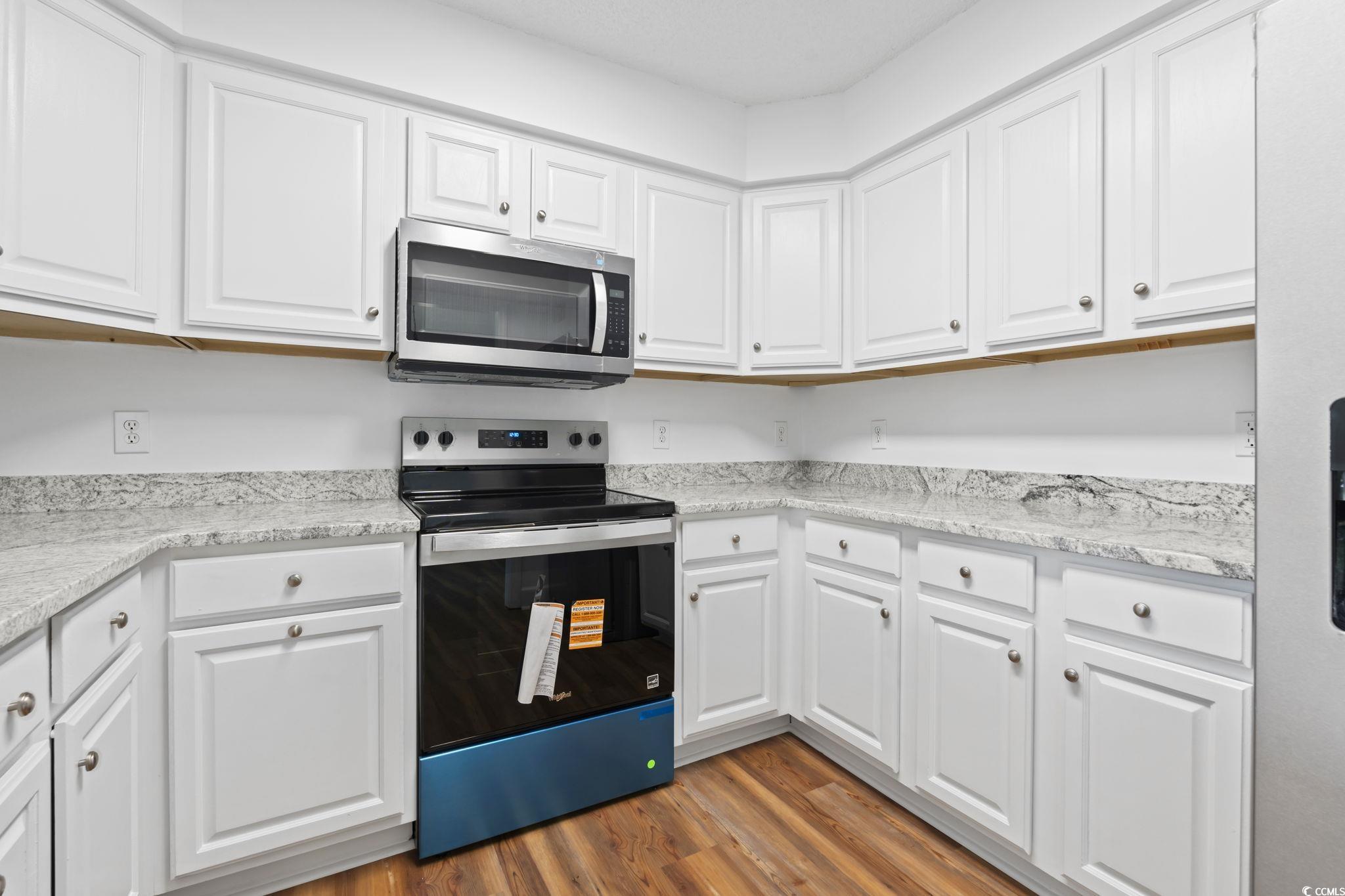 568 Rosedale Drive Aynor, SC 29511 - Photo 11 of 38 Kitchen featuring stainless steel appliances, white cabinets, light wood-style flooring, and light stone counters