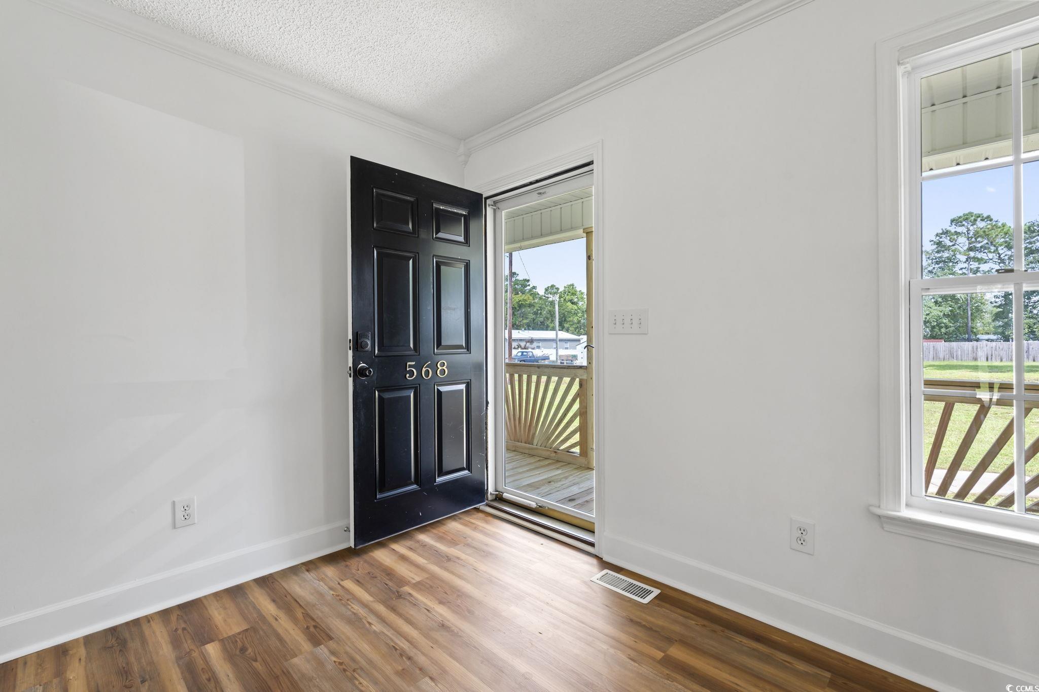 568 Rosedale Drive Aynor, SC 29511 - Photo 4 of 38 Entryway with ornamental molding, wood finished floors, and a textured ceiling