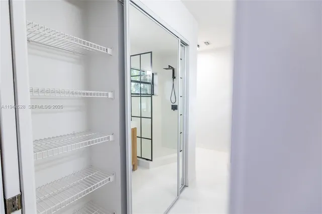 a bathroom with a glass shower door
