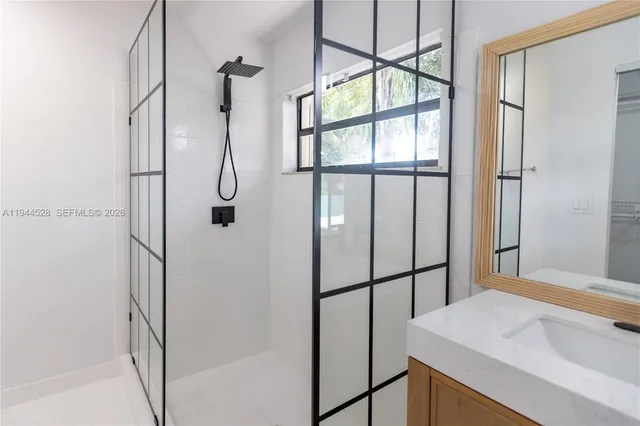 a bathroom with a shower and a sink