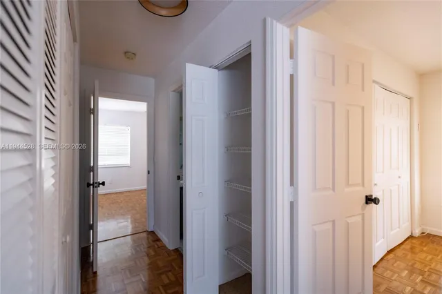 a view of a hallway with a white walls and a curtain
