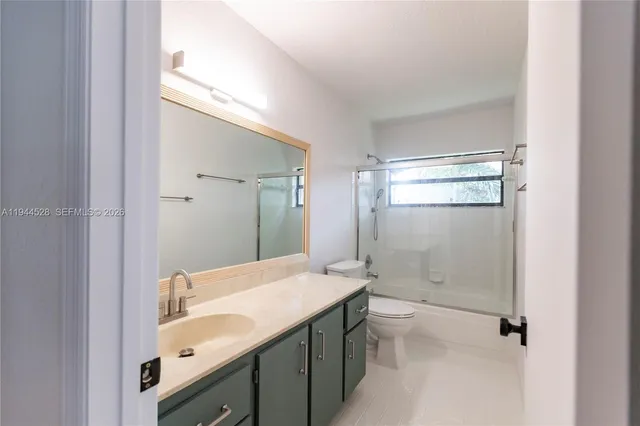 a bathroom with a sink vanity and mirror