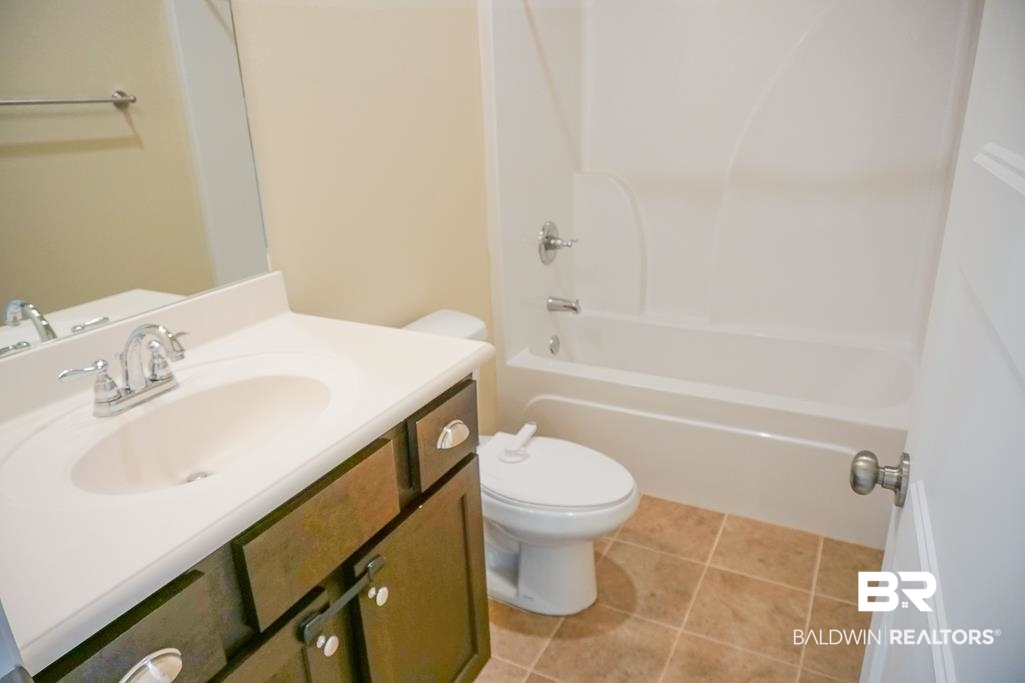 593 Begeman Road Mobile, AL 36608 - Photo 18 of 23 Full bathroom with tile floors, tub / shower combination, toilet, and large vanity
