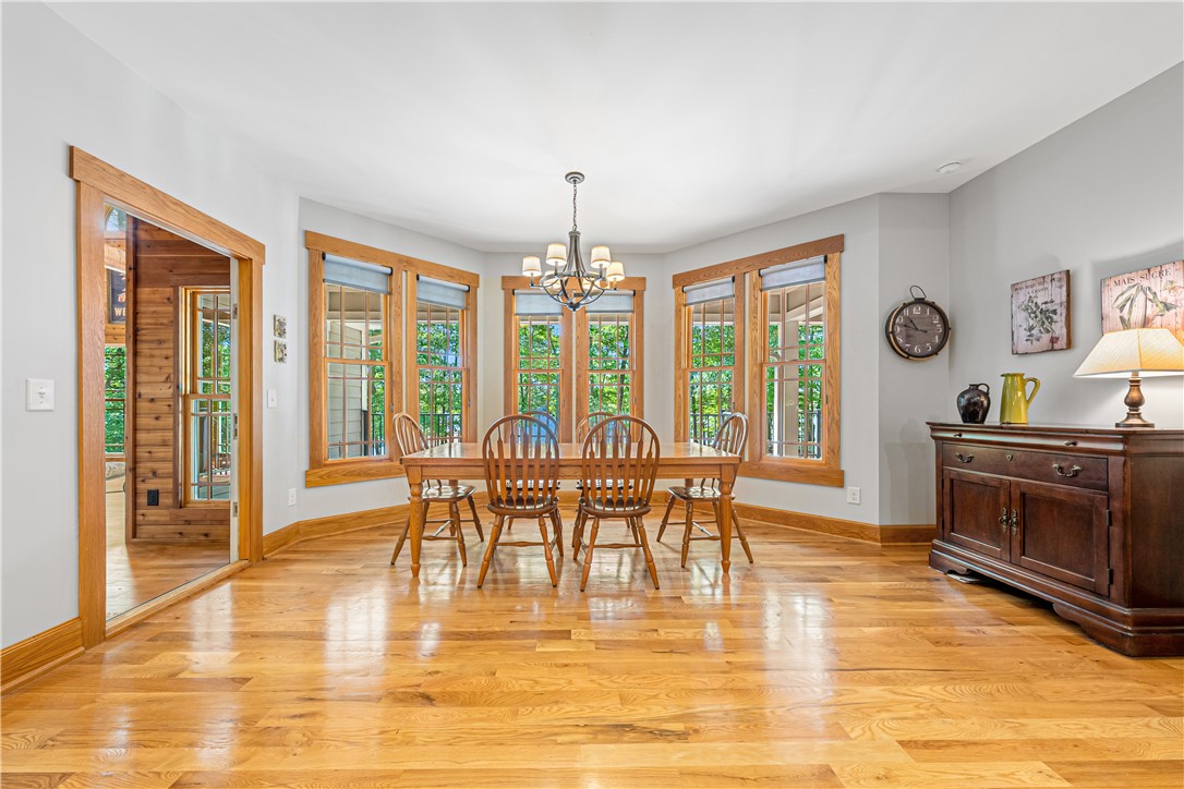 285 Bertha Allen Road Westminster, SC 29693 - Photo 15 of 50 A refined dining space features natural light through multiple windows and gleaming hardwood flooring.