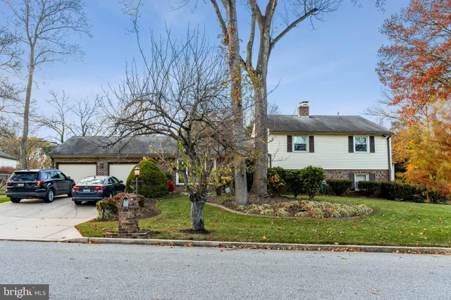 a view of a parked cars in front of a brick house