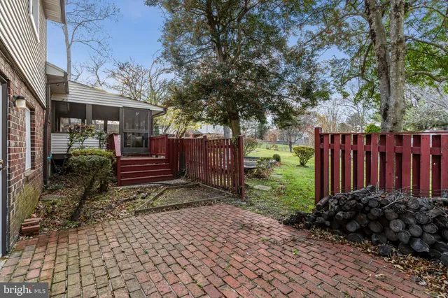 a view of a house with a small yard and wooden fence