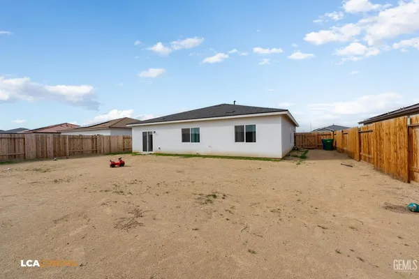 a view of a house with wooden fence