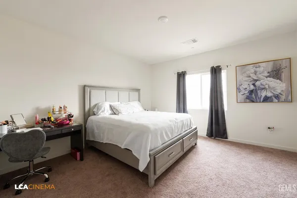 a bed sitting in a bedroom next to a window