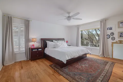 a bedroom with a bed and large mirror