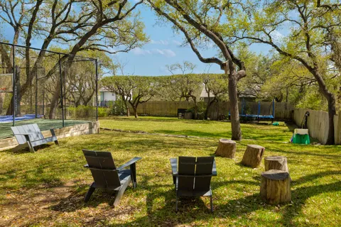 a swimming pool with outdoor seating and yard