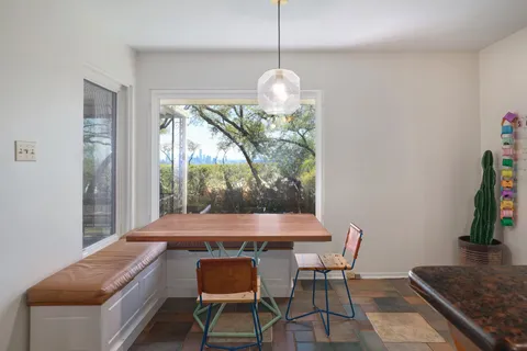 a view of a dining room with furniture window and outside view