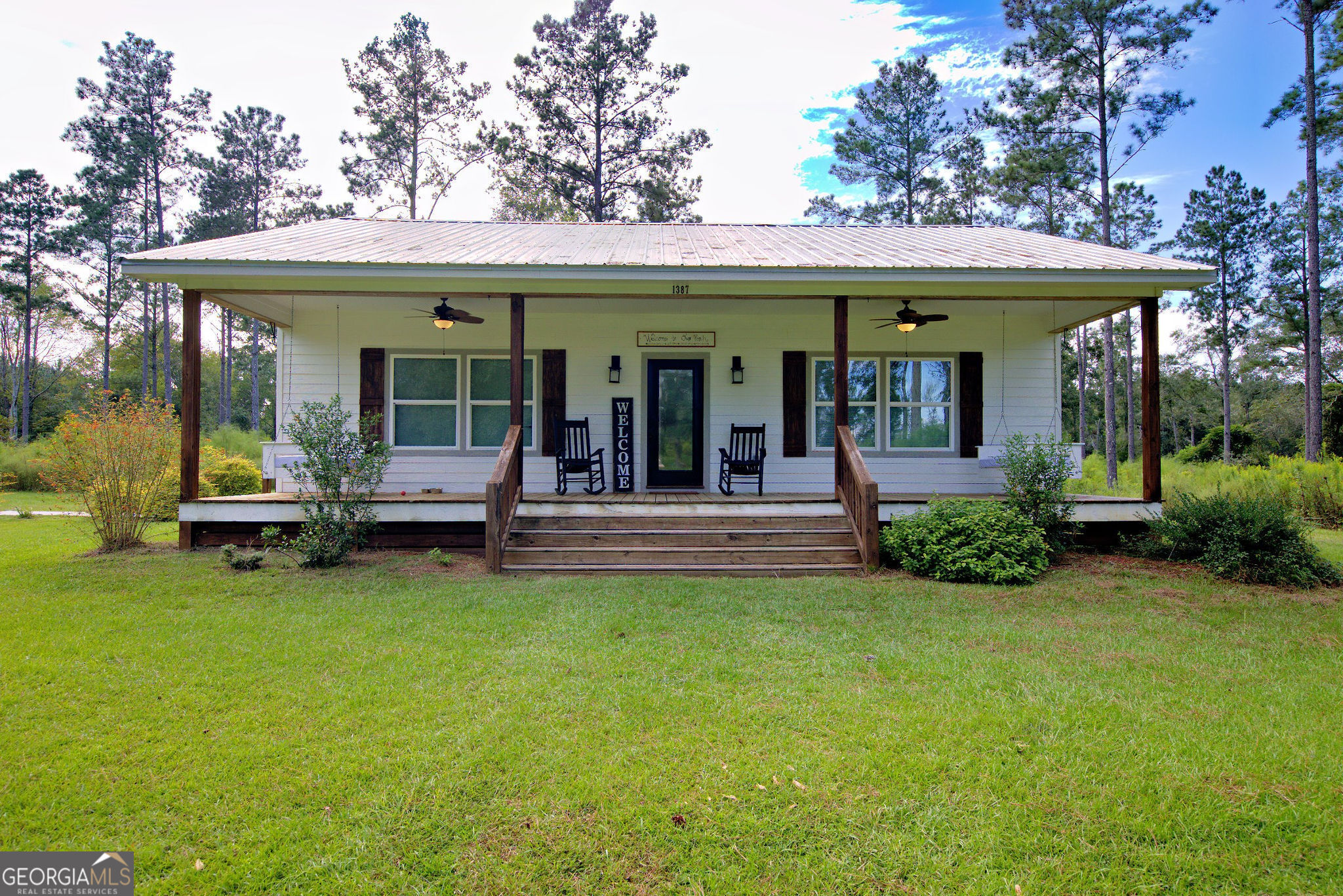 a view of a house with swimming pool and porch with a slide