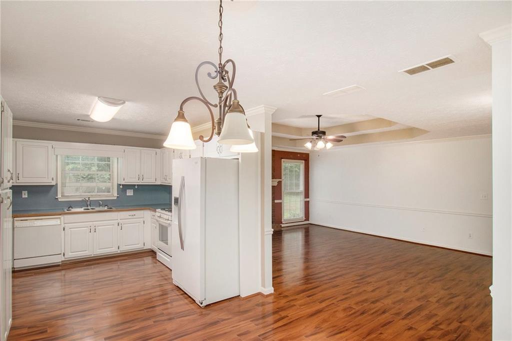 340 Radcliff Trace Covington, GA 30016 - Photo 11 of 38 a view of a kitchen with a sink cabinets and wooden floor