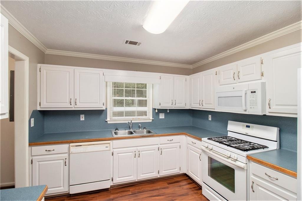 340 Radcliff Trace Covington, GA 30016 - Photo 13 of 38 a kitchen with granite countertop cabinets stainless steel appliances and a sink