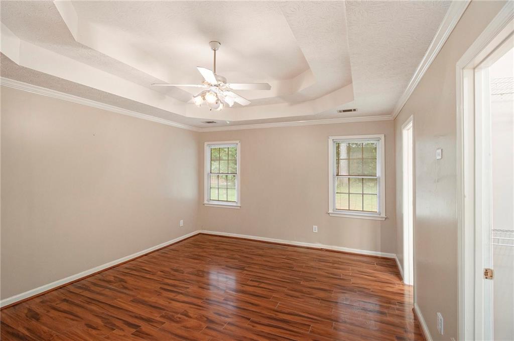340 Radcliff Trace Covington, GA 30016 - Photo 16 of 38 a view of an empty room with wooden floor and a window