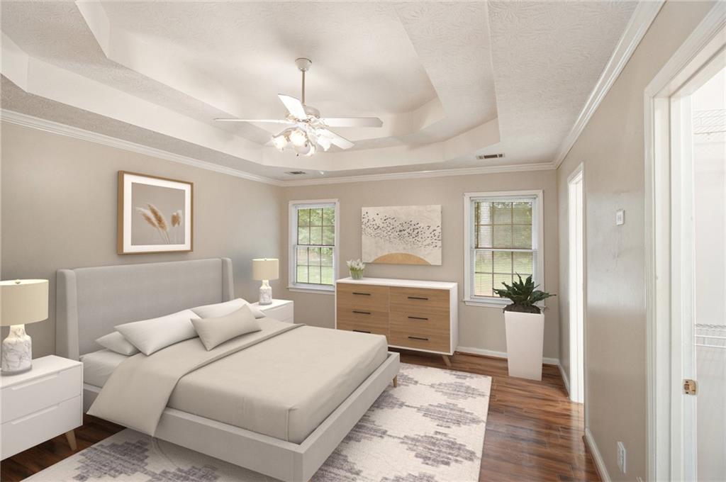 340 Radcliff Trace Covington, GA 30016 - Photo 17 of 38 a bedroom with a large bed and a chandelier
