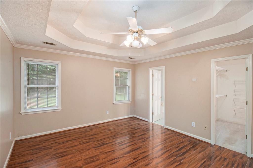 340 Radcliff Trace Covington, GA 30016 - Photo 18 of 38 a view of an empty room with wooden floor and a window
