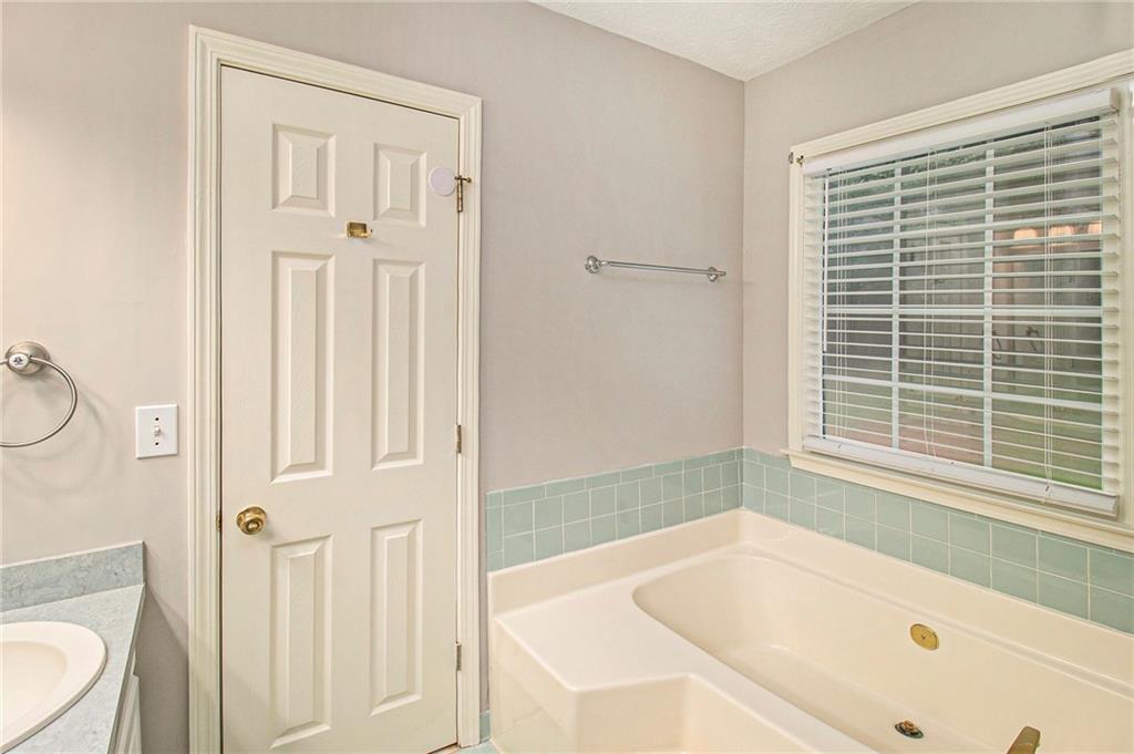 340 Radcliff Trace Covington, GA 30016 - Photo 19 of 38 a white bath tub sitting next to a window