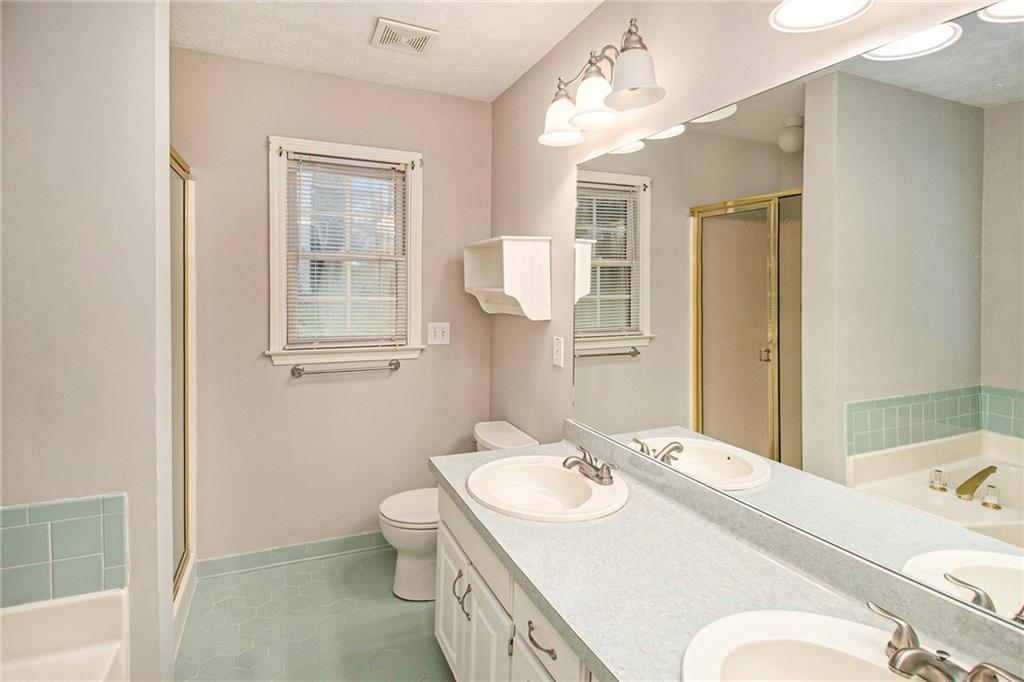 340 Radcliff Trace Covington, GA 30016 - Photo 20 of 38 a bathroom with a sink toilet and mirror