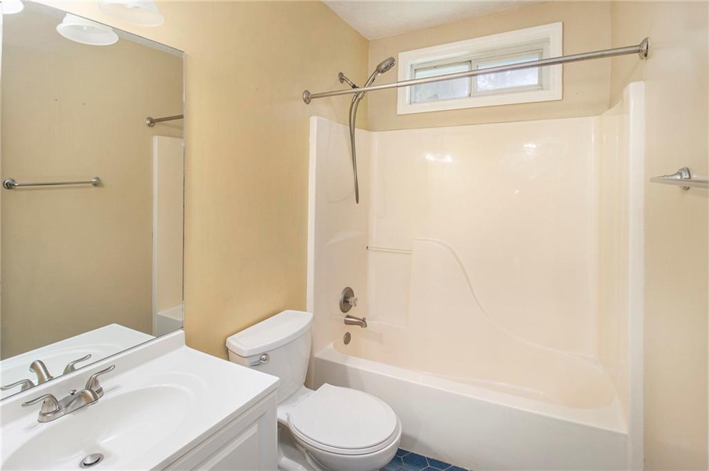 340 Radcliff Trace Covington, GA 30016 - Photo 22 of 38 a bathroom with a sink toilet and shower