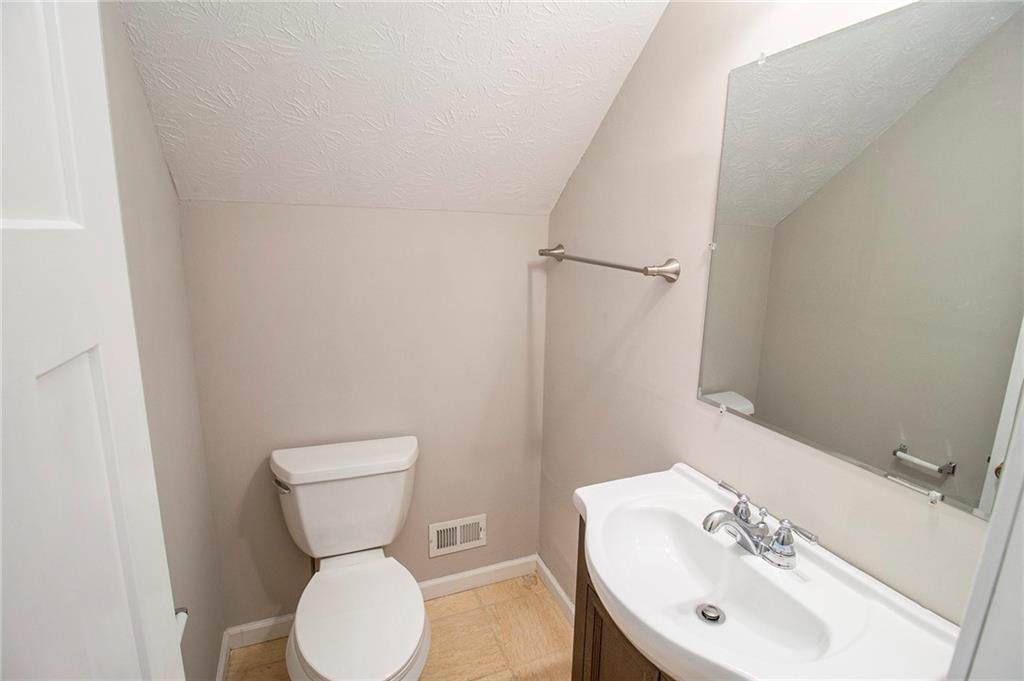 340 Radcliff Trace Covington, GA 30016 - Photo 26 of 38 a bathroom with a toilet sink and mirror