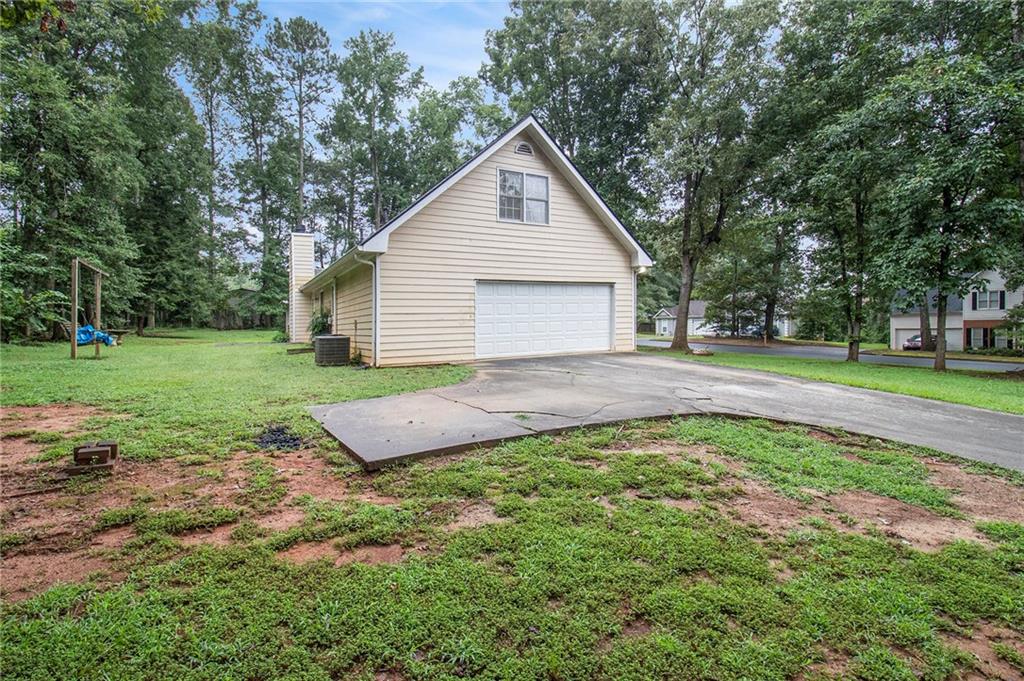 340 Radcliff Trace Covington, GA 30016 - Photo 27 of 38 a view of a house with a yard and large trees