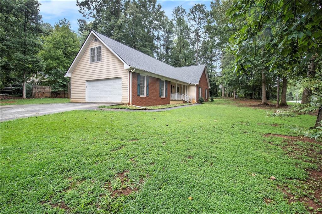 340 Radcliff Trace Covington, GA 30016 - Photo 3 of 38 a view of a yard in front of a house with large trees