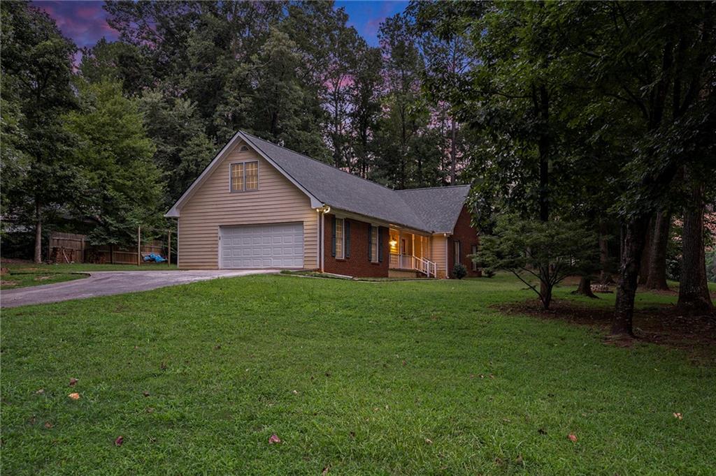 340 Radcliff Trace Covington, GA 30016 - Photo 33 of 38 a view of a yard in front of a house with large trees