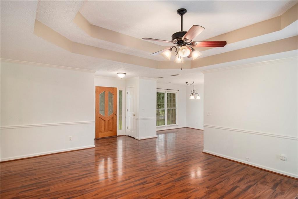 340 Radcliff Trace Covington, GA 30016 - Photo 5 of 38 a view of an empty room with window and wooden floor