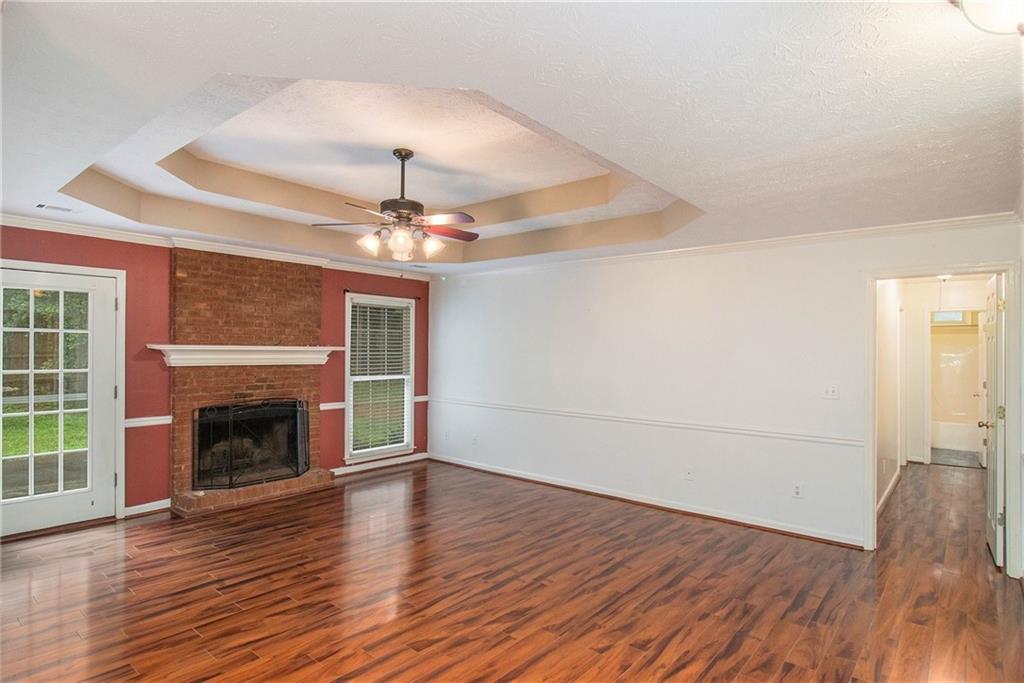 340 Radcliff Trace Covington, GA 30016 - Photo 6 of 38 wooden floor fireplace and windows in an empty room