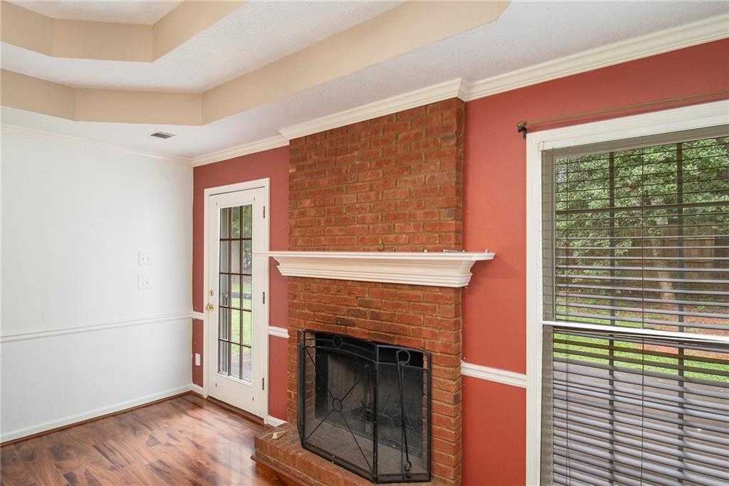 340 Radcliff Trace Covington, GA 30016 - Photo 10 of 38 a living room with a fireplace and a floor to ceiling window
