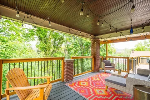 a balcony with furniture and wooden floor