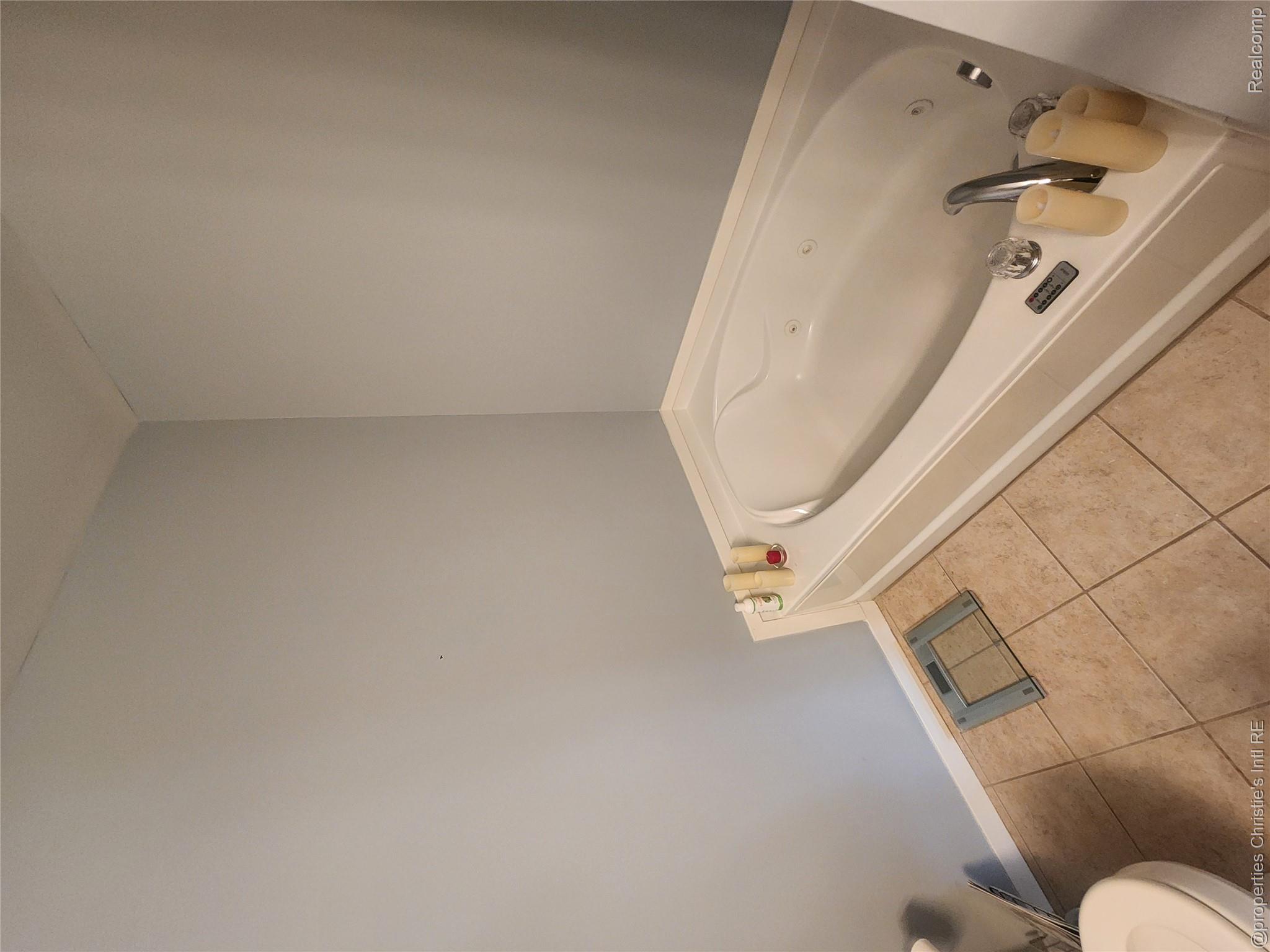 66 Winder Street, Unit 458 Detroit, MI 48201 - Photo 13 of 19 Full bathroom with light tile patterned floors and a bath