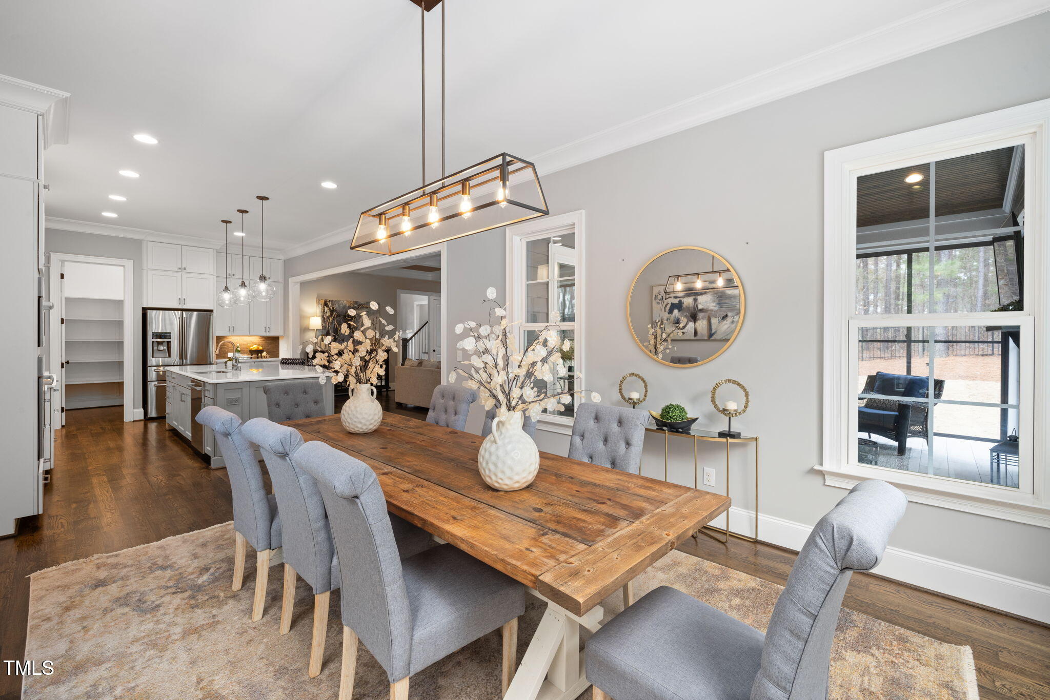 170 Pine Cone Loop Pittsboro, NC 27312 - Photo 20 of 58 a view of a dining room and livingroom with furniture wooden floor a rug a painting and a chandelier