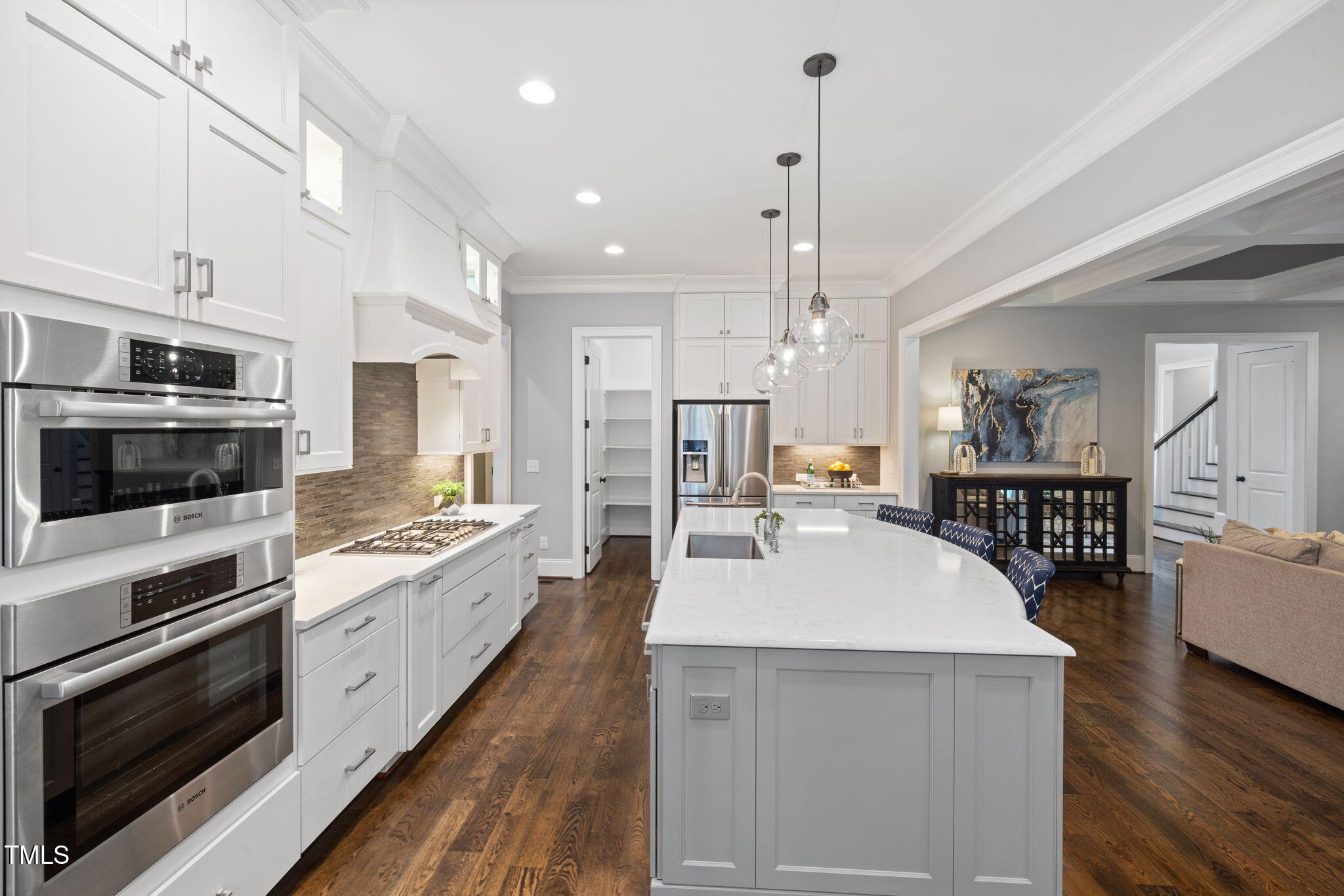 170 Pine Cone Loop Pittsboro, NC 27312 - Photo 22 of 58 a large kitchen with kitchen island a stove a sink a center island and wooden floor