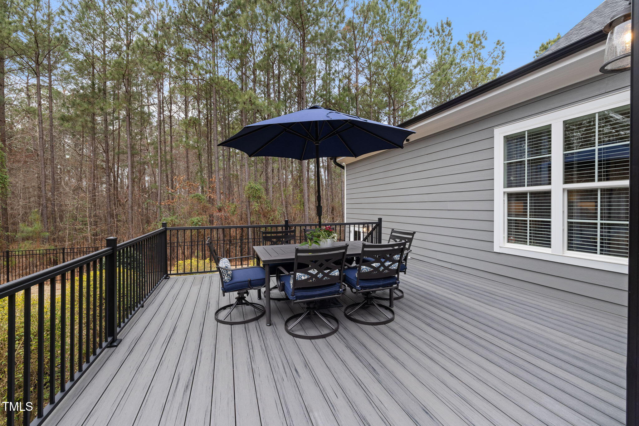 170 Pine Cone Loop Pittsboro, NC 27312 - Photo 53 of 58 a view of deck with table and chairs under an umbrella with wooden floor and fence