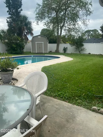 a view of a house with backyard porch and sitting area
