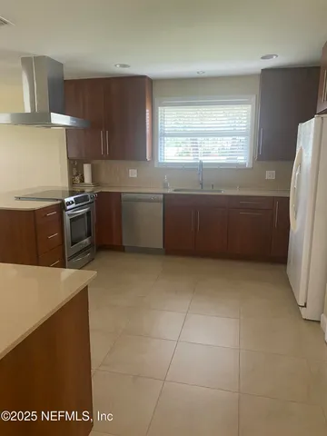 a kitchen with a stove a refrigerator and cabinets