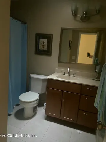 a bathroom with a sink toilet and mirror