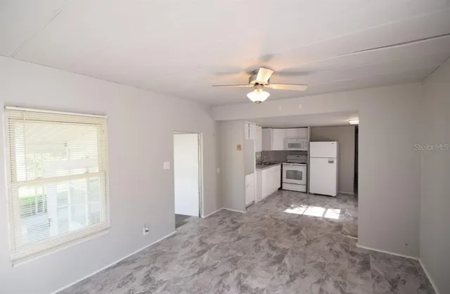 a view of a kitchen with a sink cabinets and a window