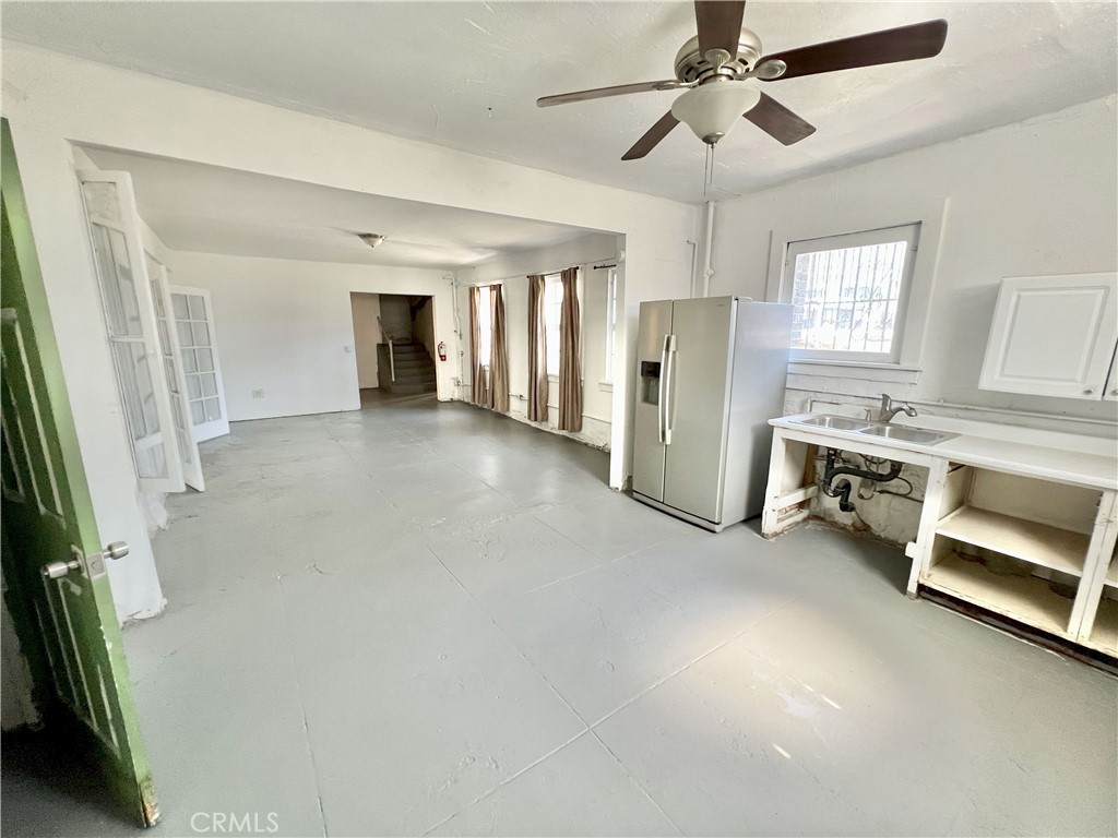 606 East 6th Street Los Angeles, CA 90021 - Photo 11 of 20 a view of a livingroom with a fireplace a ceiling fan and wooden floor