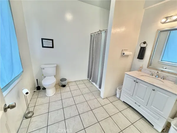 a bathroom with a double vanity sink mirror and toilet