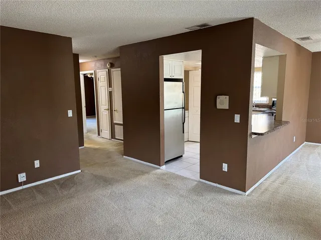 an empty room with closet and windows