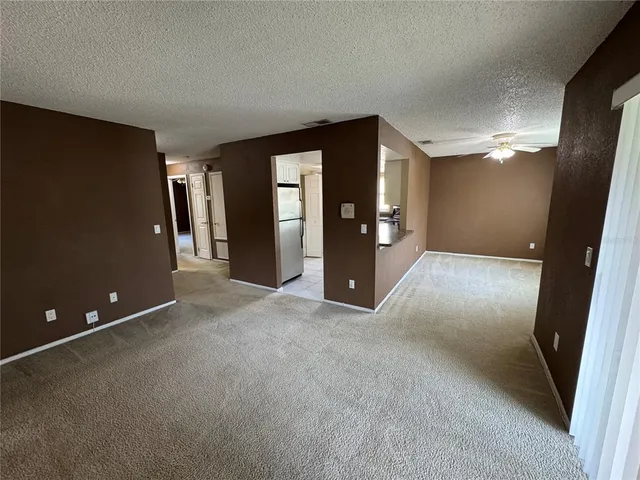 an empty room with closet and windows