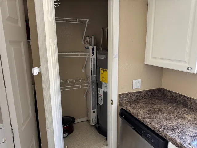 a kitchen with a refrigerator and cabinets